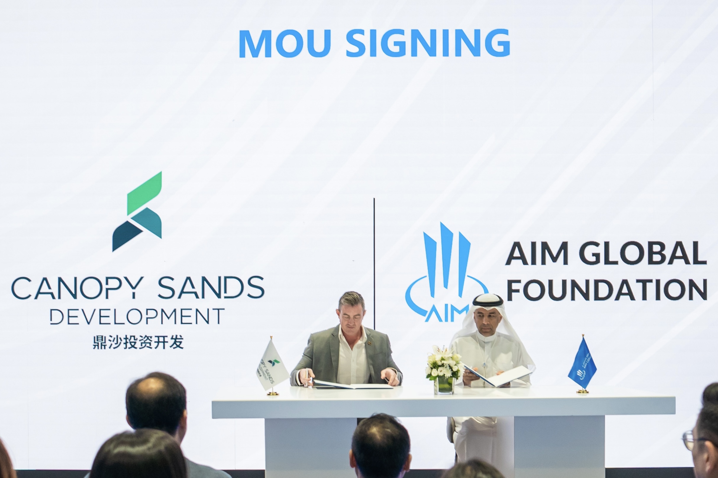 Representatives from AIM Global Foundation and Canopy Sands Development sign a MOU at the 2024 AIM Congress, initiating a landmark convention center project in Sihanoukville, Cambodia.